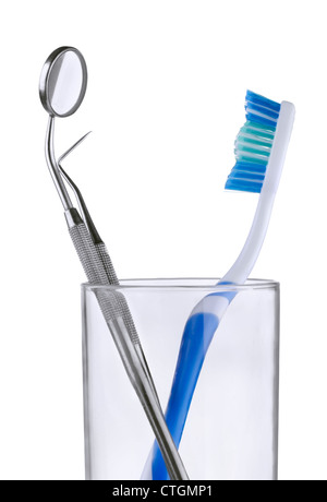 Dental mirror. explorer and toothbrush in glass on white background Stock Photo