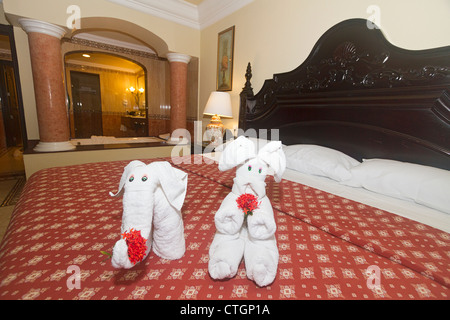 Animal towel art in the for of an elephant and rabbit on the bed of a guest room at Riu Palace Riviera Maya, Mexico Stock Photo