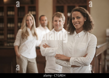 Wait staff standing in restaurant Stock Photo