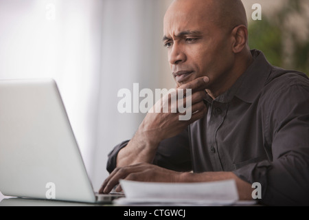 Black man using laptop Stock Photo