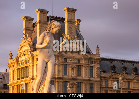 Statue in Jardin des Tuileries with Musee du Louvre beyond, Paris France Stock Photo