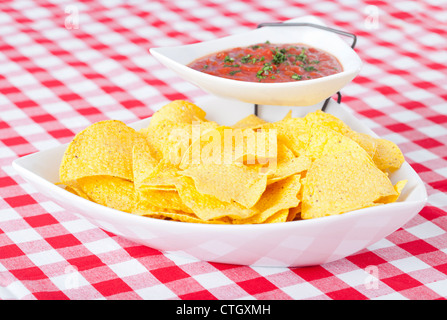Chips and salsa on checkered tablecloth Stock Photo