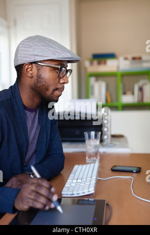 Black designer working at desk Stock Photo