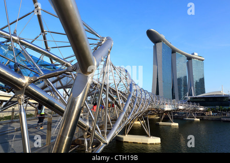 View of the Helix Bridge and the Marina Bay Sands hotel and Skypark in Singapore. Stock Photo