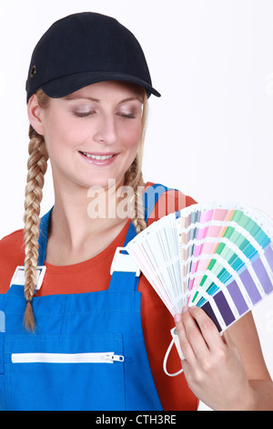 Woman choosing which color paint to use Stock Photo