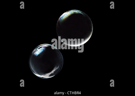 two soap bubbles on black background Stock Photo