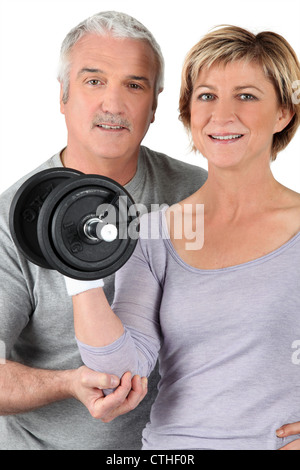Couple using gym weights Stock Photo
