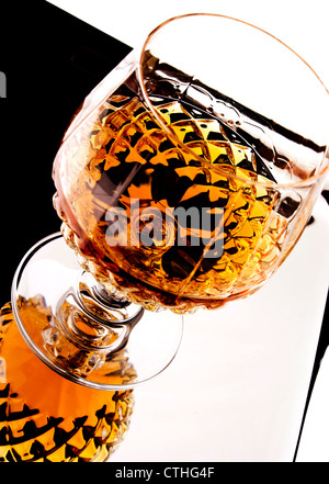 Whiskey in crystal stem glass on silver tray. Stock Photo