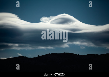 Lenticular cloud formation with a distinctive crashing wave top over Colorado's Rocky Mountains. Stock Photo