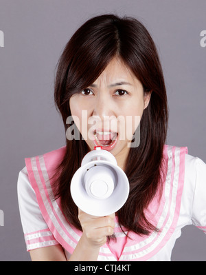 School girl screams via speaker. Stock Photo