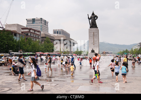 People enjoying hot summer day in Gwanghwamun Square, Seoul, Korea Stock Photo