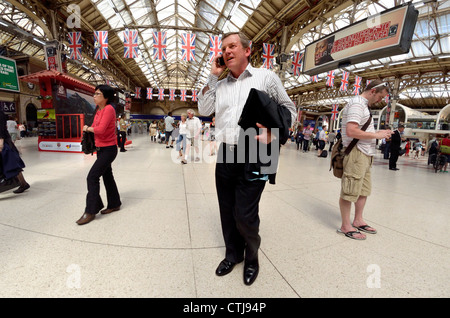 London, England, UK. Victoria Station. Man on mobile phone Stock Photo