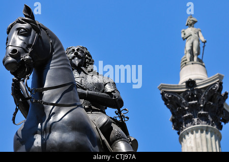London, England, UK. Statue: Charles I (1633 - Hubert le Sueur) in Trafalgar Square. Nelson's Column behind Stock Photo