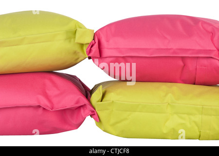 bright stack of pink and green pillows isolated on white Stock Photo