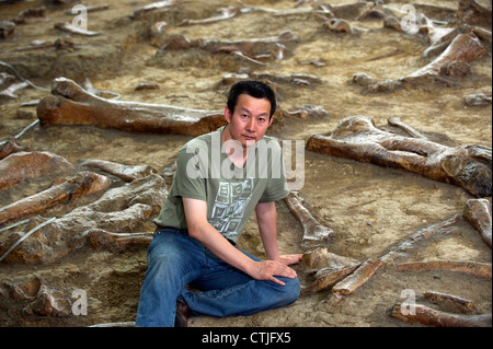 Chinese palaeontologist Dr. Xu Xing walks among the remains of duck ...