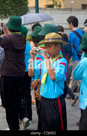 Thai school students wearing Scouting uniforms visit The Grand Palace in Bangkok, Thailand. Stock Photo
