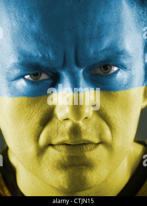 Closeup of young Ukrainian supporter face painted with national flag colors Stock Photo