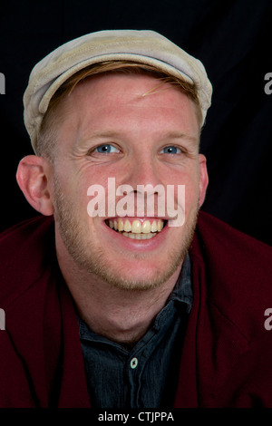 Portrait of a young man with cap laughing Stock Photo