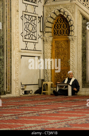 Old man praying at The Umayyad Mosque,  the Great Mosque of Damascus, Syria. Stock Photo