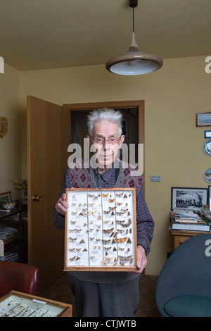 Man holding framed insect collection,  Iceland Stock Photo