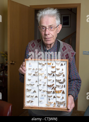 Man holding framed insect collection,  Iceland Stock Photo