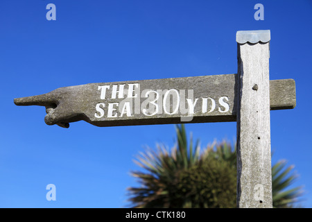 Wooden signpost pointing to the sea, Meon Shore, Fareham, Hampshire, England, UK Stock Photo