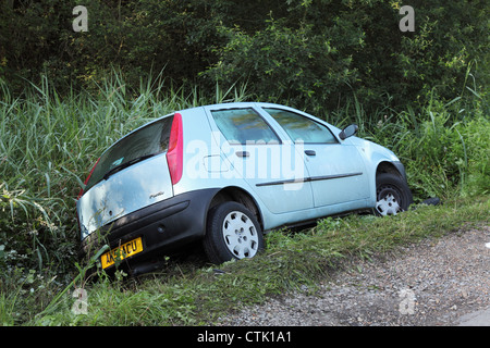 Fiat Punto car in ditch following acute bend near Meon Shore, Fareham, England UK Stock Photo