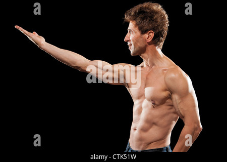 older mens physical health strong muscles 50 year old body fitness body building sport on black background Stock Photo