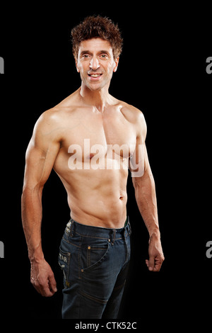 older mens physical health strong muscles 50 year old body fitness body building sport on black background Stock Photo