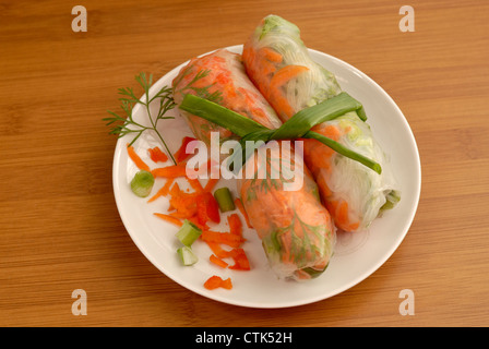 Vietnamese style Spring Rolls, garnished and tied together with a green onion. Stock Photo