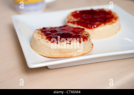 afternoon tea with two crumpets with strawberry jam Stock Photo