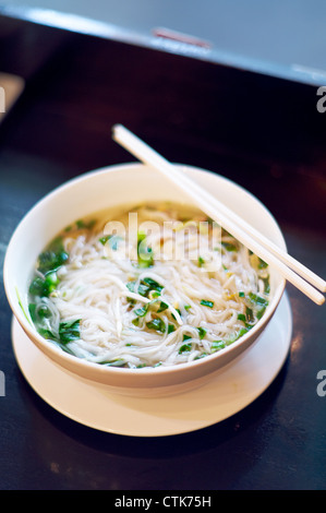 A fresh warm bowl of Pho, a traditional Vietnamese noodle soup dish. Stock Photo