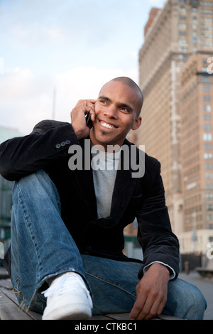 Happy man talking on cellphone outdoors Stock Photo