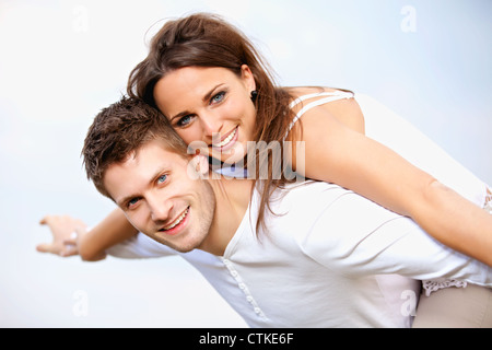 Portrait of a happy young couple enjoying their summer vacation, isolated on bright background Stock Photo