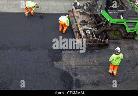 Road being resurfaced with new layer of tarmac asphalt Stock Photo