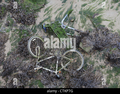 Abandoned bicycle and shopping trolley within Portsmouth harbour England Stock Photo