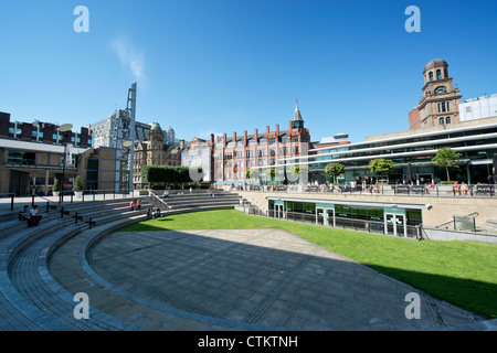 People enjoy themselves in a small amphitheatre behind Peter Street in Manchester on a sunny summer's day. Stock Photo