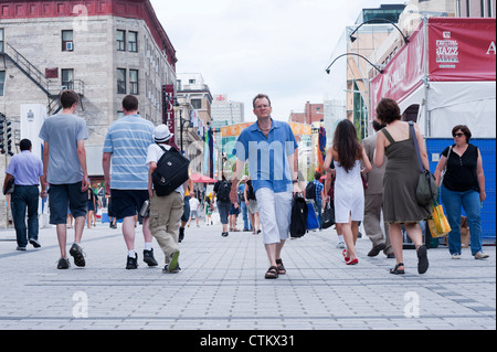 Pedestrians on a part Ste Catherine street which is closed to ...