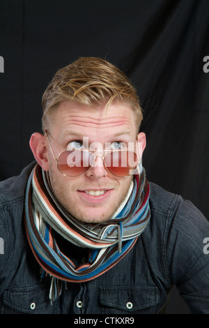 Young man with scarf, showing different expressions Stock Photo