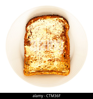 A slice of seeded toast and butter on a white background Stock Photo