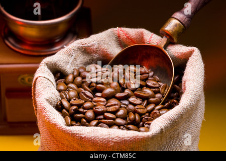 Sack of coffee beans and scoop. On a dark background. Stock Photo
