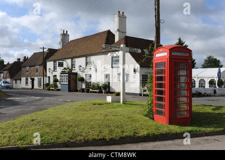 The Five Bells Inn traditional English pub at Rabourne village in Kent UK with old fashioned red telephone box Stock Photo