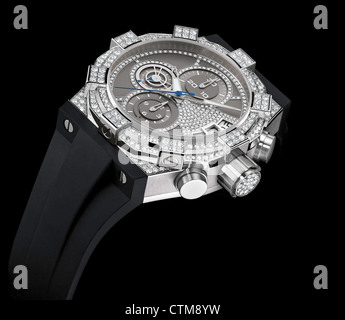 High Luxury Ladies wrist watch with diamond dial, diamond bezezl and diamond case with black rubber strap Stock Photo