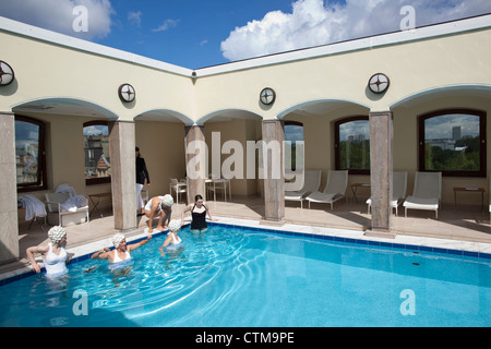 Bathers in costume and swimming caps at The Berkeley London rooftop pool, London, England, UK Stock Photo