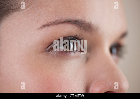Close-up of a young woman with brown eyes, side view Stock Photo
