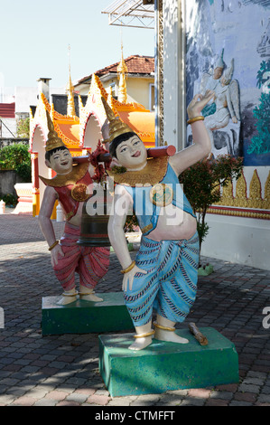 Laughing bell bearers, Dhammikarama Burmese Buddhist Temple, Georgetown, Penang, Malaysia. Stock Photo