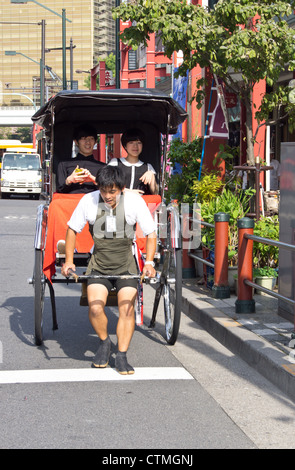 A foot rickshaw in operation for tourists in Tokyo Japan Stock Photo