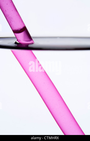 Drinking straw refracted by water Stock Photo