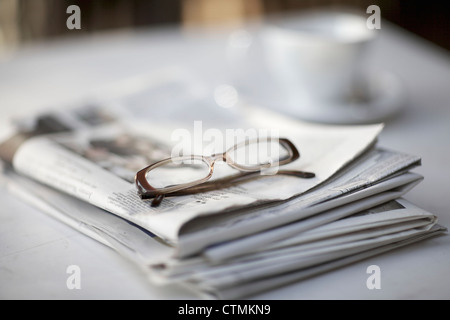 A pair of reading glasses sitting on top of a newspaper, Johannesburg, Gauteng, South Africa Stock Photo