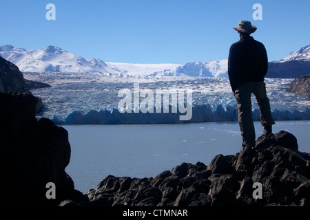 A trekker admires Glacier Grey, Torres del Paine National Park, Patagonia, Chile, South America Stock Photo